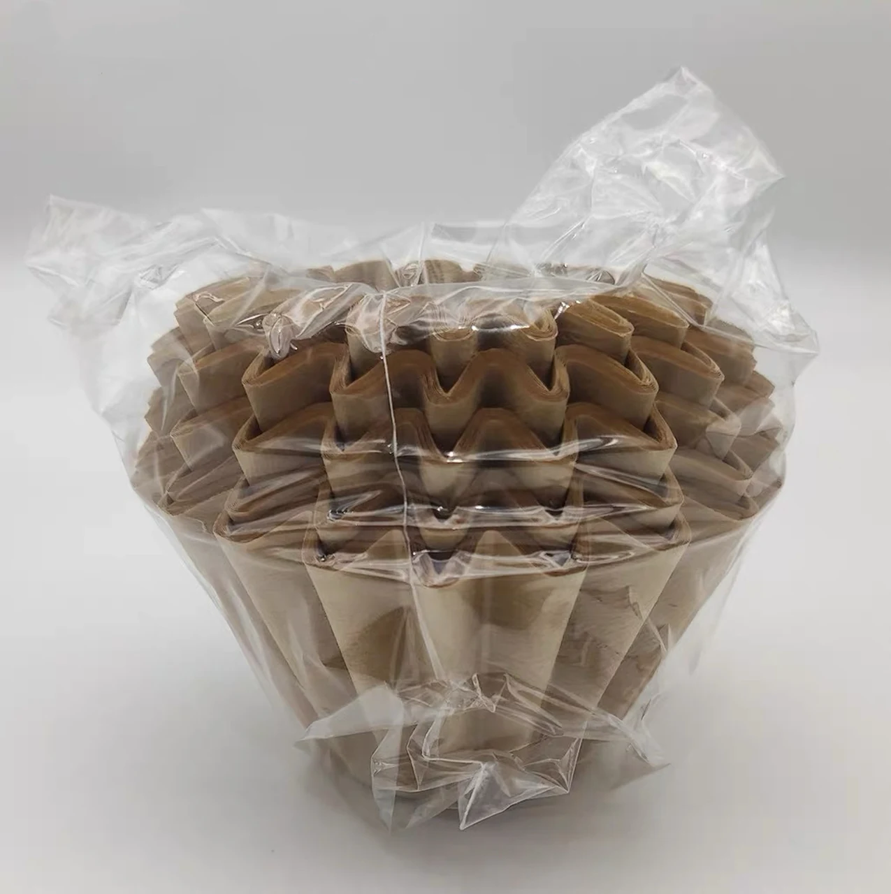 Natural-brown basket coffee filters in a clear bag.