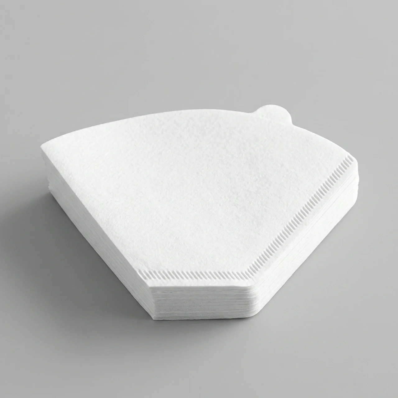 White fan-shaped coffee filter papers.
